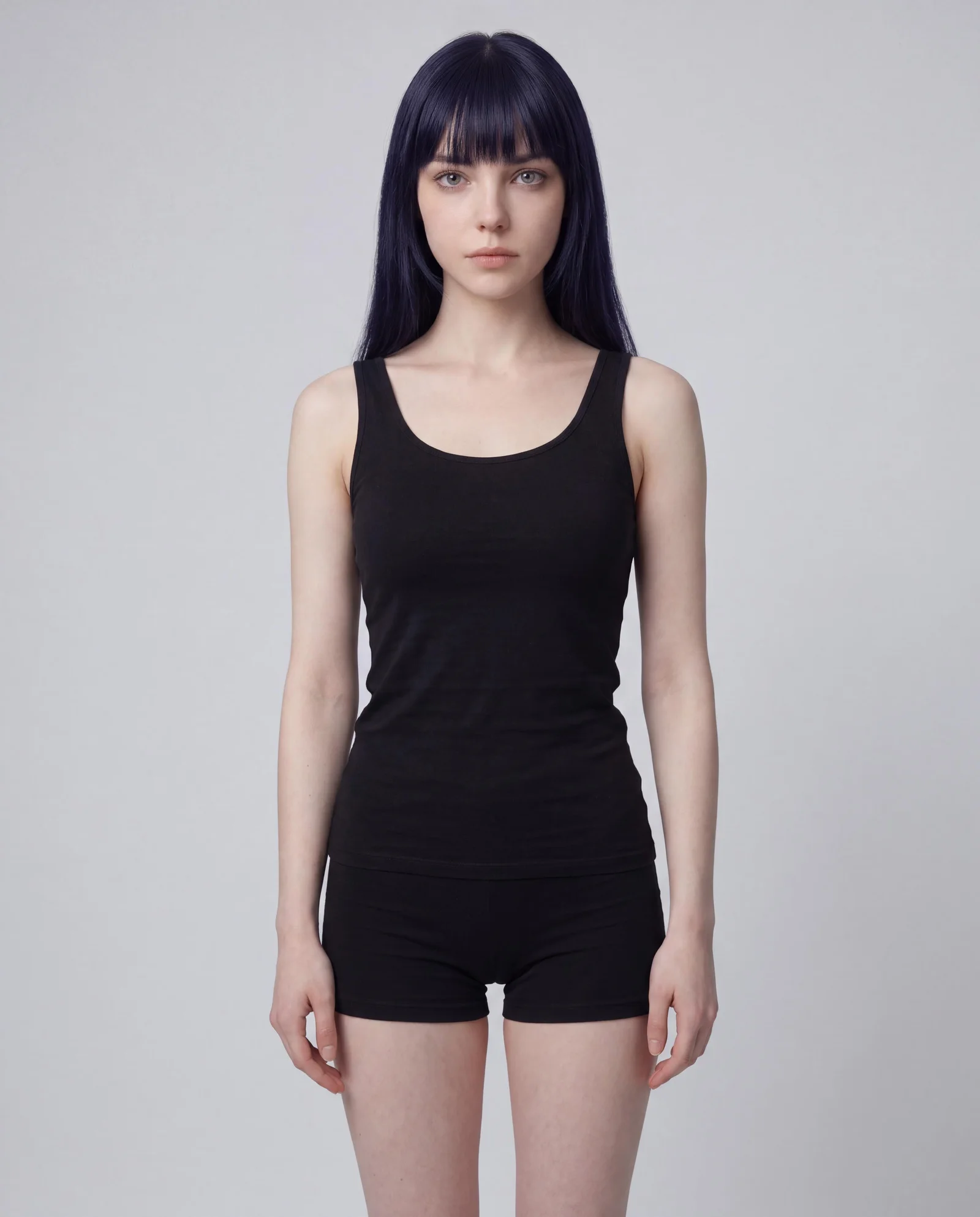 Identity reference plate: the model standing full length in plain black on a neutral studio ground
